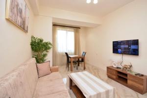 a living room with a couch and a table at Your Yerevan Home in Yerevan