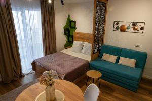 a hotel room with a bed and a couch at MunSpell Apartment in Kopaonik