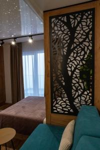 a bedroom with a tree mural on the wall at MunSpell Apartment in Kopaonik