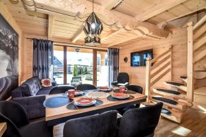 a living room with a table and chairs at Bukowiańska Osada in Bukowina Tatrzańska