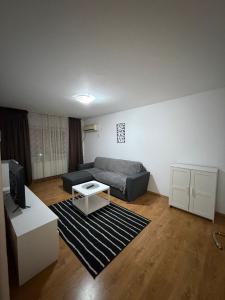 a living room with a couch and a table at Dana in Piteşti