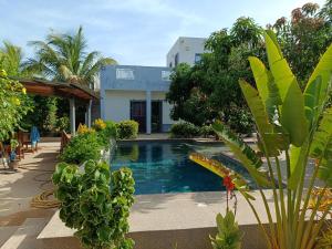 a swimming pool in front of a house at Guorgui's bed in Ndangane