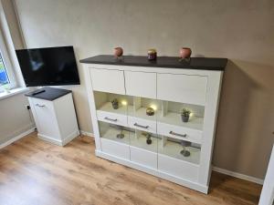 a white cabinet with vases on top of it at Seegarten in Görlitz