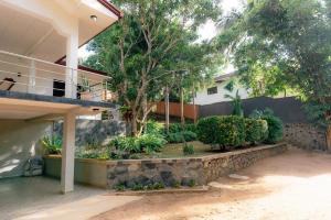 a garden in front of a house at Brescia villa - Your Private Escape in matara in Gandara West