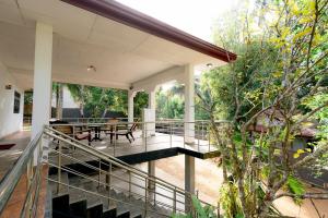 a balcony of a house with a table and chairs at Brescia villa - Your Private Escape in matara in Gandara West