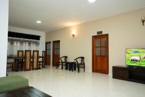 a living room with a flat screen tv on a wall at Brescia villa - Your Private Escape in matara in Gandara West