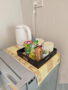 a shelf on a refrigerator with food on it at Samui Land Haven in Amphoe Koh Samui