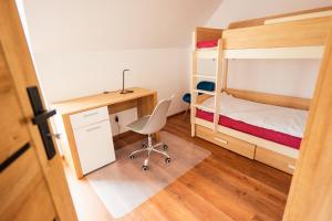 a bedroom with a desk and bunk beds at Beskid Penthouse Milówka in Milówka