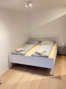a bed with two pillows on it in a room at Vogelsang Apartments in Gmunden