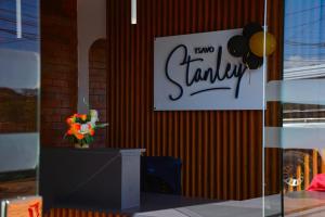 a sign on a wall with a vase of flowers at TSAVO Room 202 in Kiambu