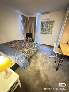 a bedroom with a bed and a desk and a table at 1B1B Private Studio near Doncaster Westfield in Doncaster