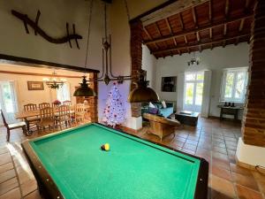 a living room with a pool table in it at Quinta do Céu Tranquilidade e Piscina no Alentejo in Alvito