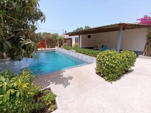 a swimming pool in the backyard of a house at Guorgui's bed in Ndangane +7 photos