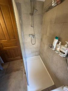 a shower with a glass door in a bathroom at Casa Inés in Penáguila +31 photos