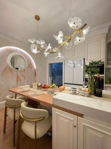 a kitchen with a table and chairs and a chandelier at York House in Exmouth