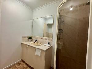 a bathroom with a sink and a shower at Private Farmhouse & Paddock Available in Werribee South