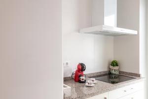 a kitchen with white walls and a counter top at Iberos Home in Seville