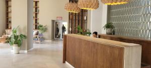 a woman sitting at a counter in a store lobby at Beachfront Harbor 171 Condo Ocean View Pool, Gym WiFi in Puerto Vallarta +27 photos