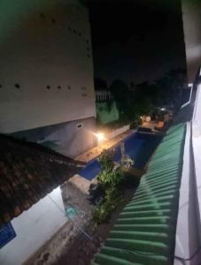 Una vista aérea de una piscina por la noche. en Mulia Legian guest house, en Seminyak