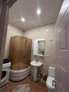 a bathroom with a shower and a sink and a toilet at Apartment 9 in Mtskheta +52 photos