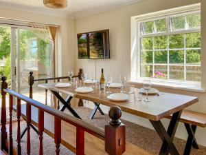 a dining room with a table with wine glasses at Harbourside - Uk50226 in Poole +27 photos