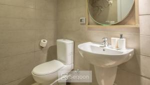 a bathroom with a toilet and a sink and a mirror at Serenity Studio in G-Cribs in El Gouna