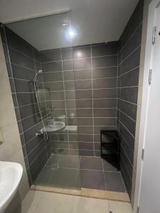 a bathroom with a shower with a sink and a toilet at Serenity Studio in G-Cribs in El Gouna