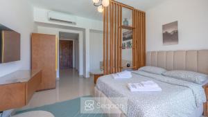 a bedroom with a bed with two towels on it at Serenity Studio in G-Cribs in El Gouna