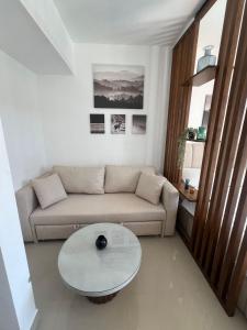 a living room with a couch and a table at Serenity Studio in G-Cribs in El Gouna
