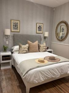a bedroom with a large bed with a hat on it at Clifton 4th Beach Villa 6 Sleeper in Cape Town