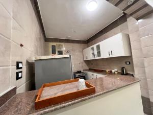 a kitchen with a counter top with a refrigerator at ElMena House Luxor in Luxor +59 photos