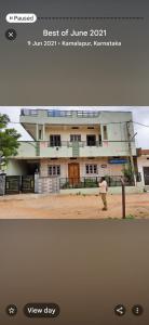 a building with a man standing in front of it at Powerstar home stay in Hampi
