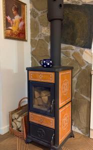 a wood stove in a room with a stone wall at Residence S5 - Comfort Living Apartment in Prešov