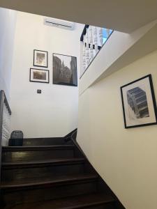 a staircase in a house with pictures on the wall at Break Time Holidays Königsee, ein Juwel im Thüringer Wald in Niederdorla