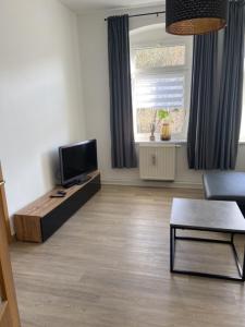 TV a/nebo společenská místnost v ubytování Ferienwohnung Fam. Falk