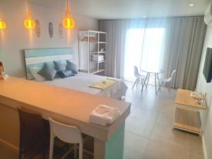 a bedroom with a bed and a table and chairs at Sunset Corner in Rivière Noire