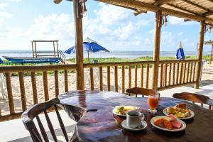 a table with food and a view of the beach at Pousada Shalom Beach in Maragogi