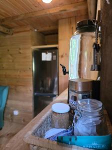 a kitchen counter with a coffee maker and a blender at La Petite Ferme, Le Chalet in Vieux Grand Port