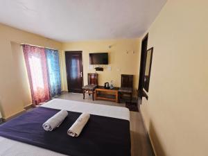 a bedroom with a large bed with two pillows on it at SmartHill Bloom-Mountain View in Dalhousie +16 photos