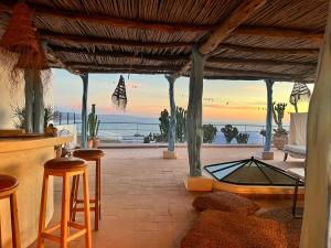 an outdoor bar with a view of the ocean at Dar Gecko in Sidi Kaouki