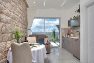 Una cocina y un comedor con mesa y sillas. en Mountain Top Views -204- נופי פסגות, en Safed