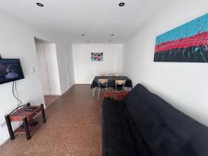 a living room with a couch and a table at 2 Ambientes Gascon in Mar del Plata