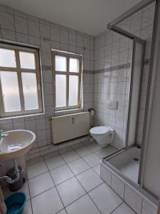 a bathroom with a tub and a toilet and a sink at Gemütliche zentrale Wohnung in Eisenach