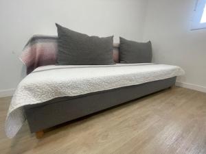 a bed with two pillows on it in a room at Céntrico apartamento muralla 2 in Lugo