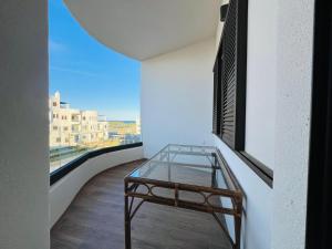 a glass table in a room with a window at Colina Smir par Immo Marina Vacances de Rêve B1-10 in Oulad Akkou
