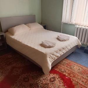 a bed with two pillows on it in a bedroom at Mary&George in Sectorul Botanica