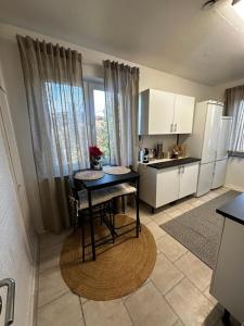 a kitchen with a table and a small table in a room at Apartment close to city in Malmö