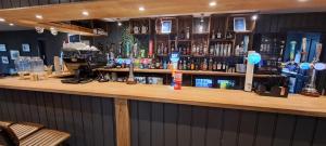 a bar with a lot of bottles of alcohol at Blue Lagoon Holiday ,Bude 79 in Cubert +18 photos