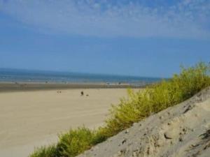 a sandy beach with people walking on the sand at Appartement en bord de mer pour 4 pers avec balcon, parking et animaux admis - FR-1-236-169 in Cucq