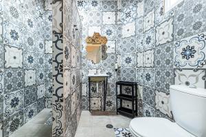 a bathroom with blue and white tiles on the wall at Arbutus Bed and Bar in Portimão +19 photos